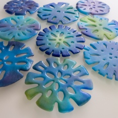 Pendants composed of sifted glass powder in a pretty mix of greens, blues and purples!