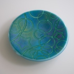 6" "batiky" dish in a blend of greens, blues, purples on robin's egg sheet glass